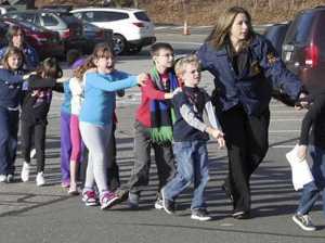 Police lead children away from Sandy Hook Elementary. AP Photo/Newton Bee/Shannon Hicks