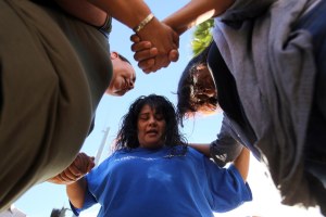 Marie Cabrera, Sonya Gonzalez and Christine Duran pray after the shooting. Rick Loomis / Los Angeles Times via Getty Images