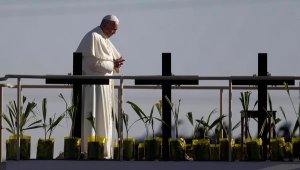 Pope Francis stands a platform near the U.S.-Mexico border fence along the Rio Grande, in Ciudad Juarez, Mexico. (AP Photo/Eric Gay)