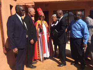 Jake Dikobo (center) speaks with the bishops after worship on Sunday.