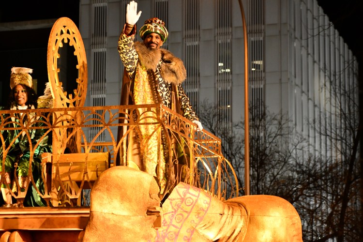 man dressed as king waving